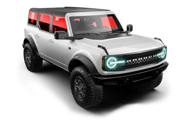 A blue tesla model s is on a black background.