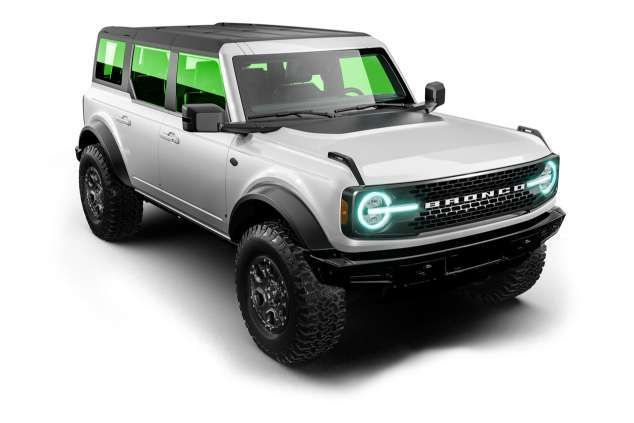 A blue tesla model s is on a black background.