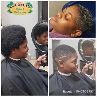 A woman is getting her hair cut at a barber shop.