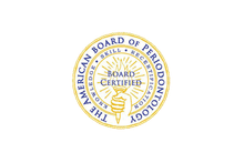 The American Board of Periodontology seal. Gold and blue colors with text and a torch symbol, signifying board certification.