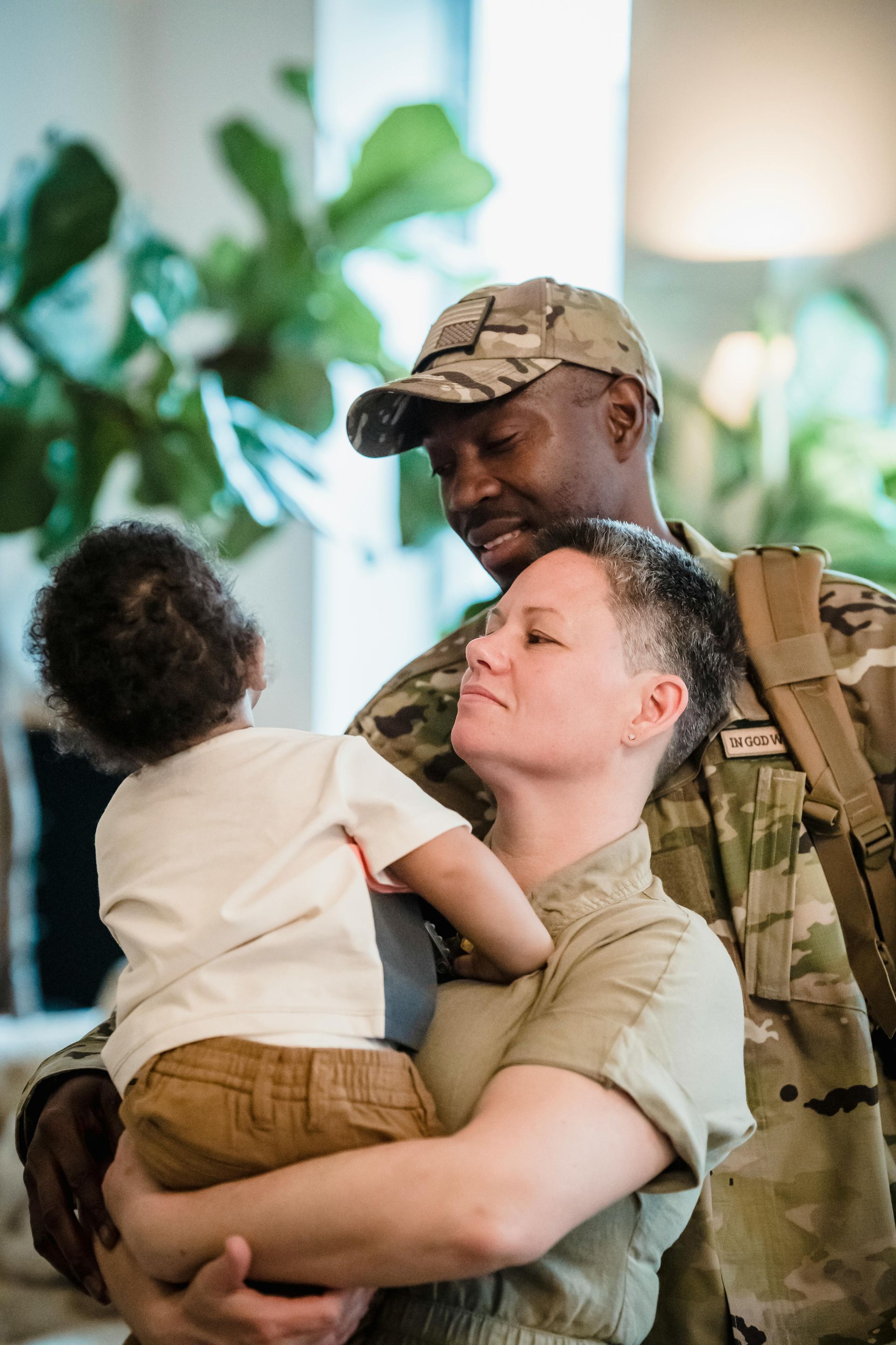 A woman is putting her hand on an American flag at a funeral.