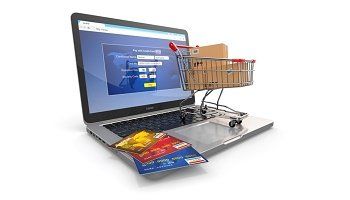 A laptop with a shopping cart and a credit card on it.