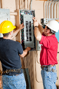 Commercial Contractor — Two Man Repairing Electrical Box in Syracuse, NY