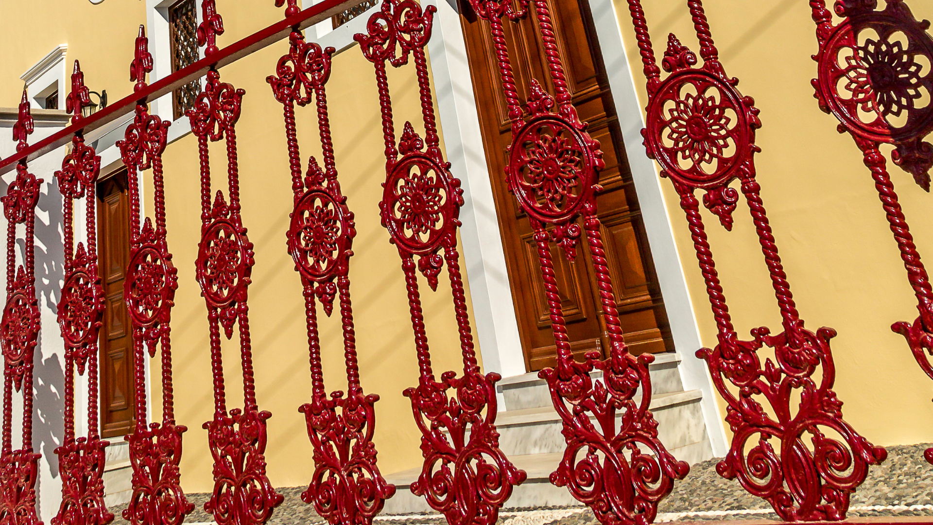 A close up of a red railing on a staircase