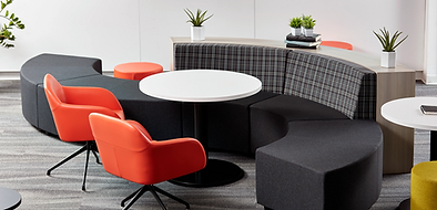 A group of chairs and tables in a room.