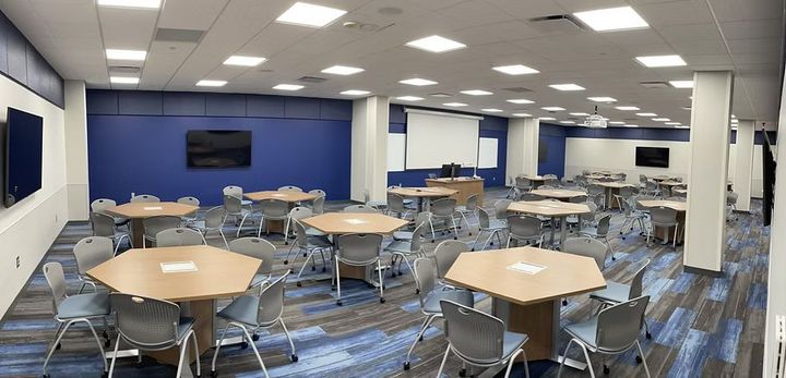 A large room with tables and chairs in it