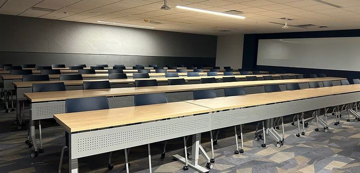 There are a lot of tables and chairs in this room.