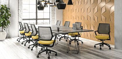A conference room with a long table and chairs.