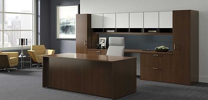There is a large desk in the middle of the room.