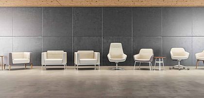 A row of white chairs are lined up in a room.