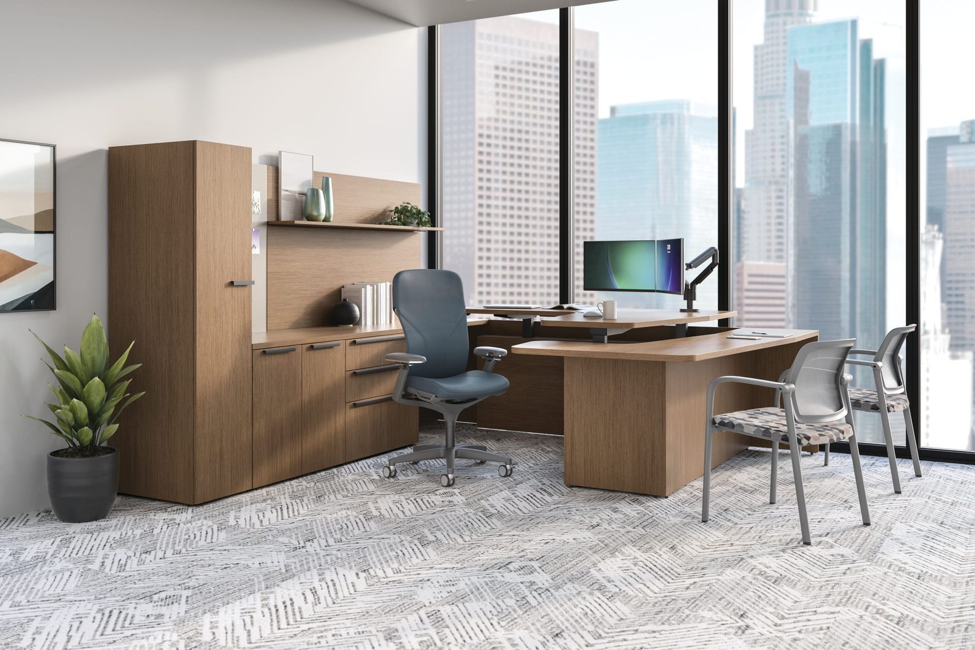 A modern office with a desk , chairs , cabinets and a computer.