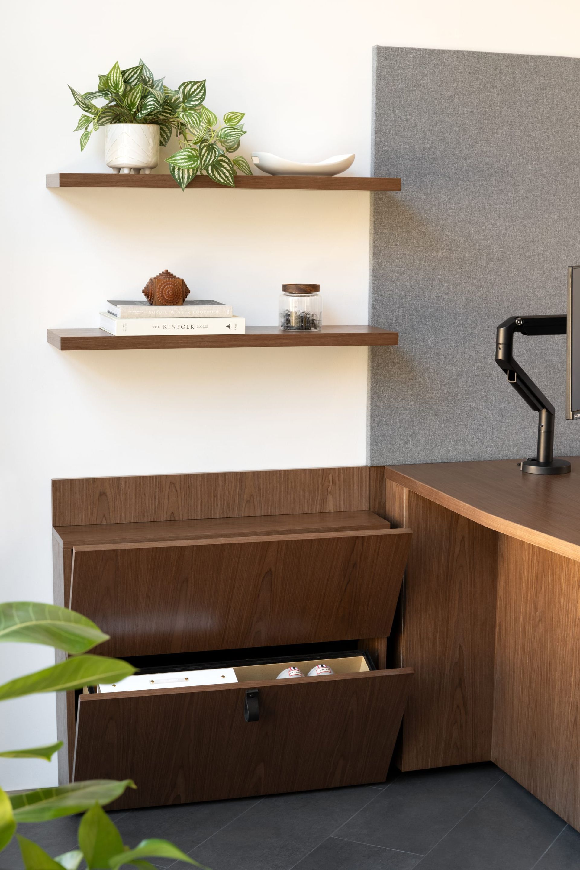A desk with a drawer underneath it and shelves above it.