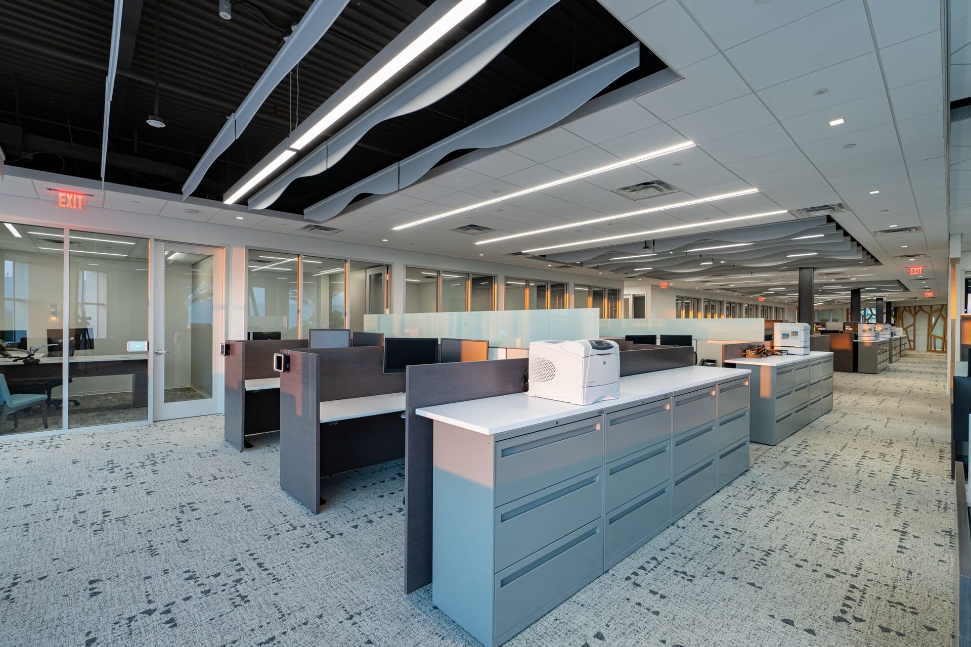 A large office with a lot of cubicles and desks.