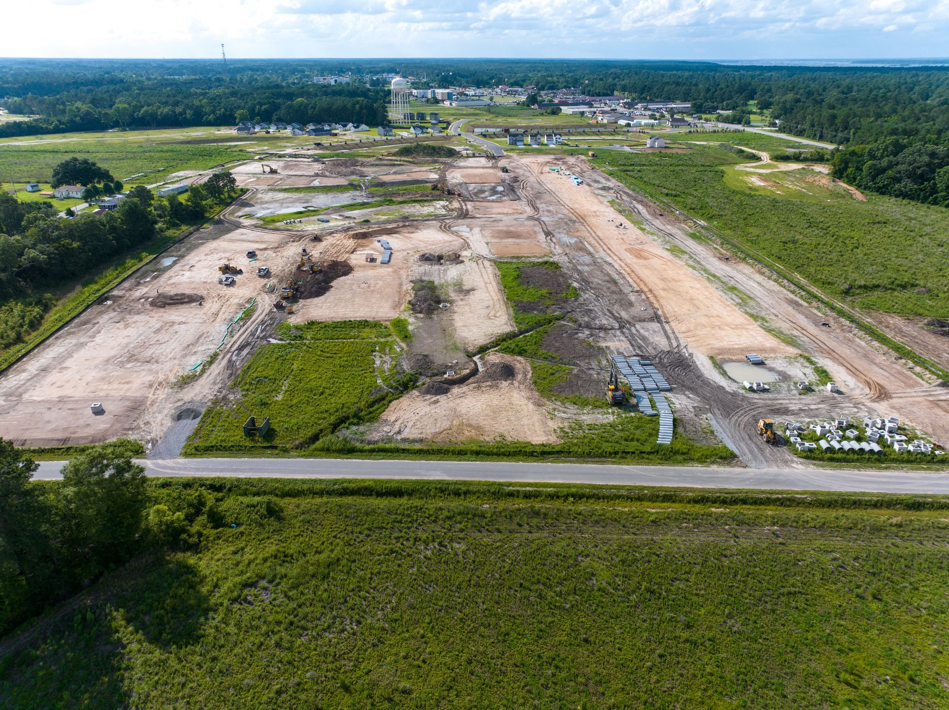An aerial view of a residential area with a roundabout in the middle of it.