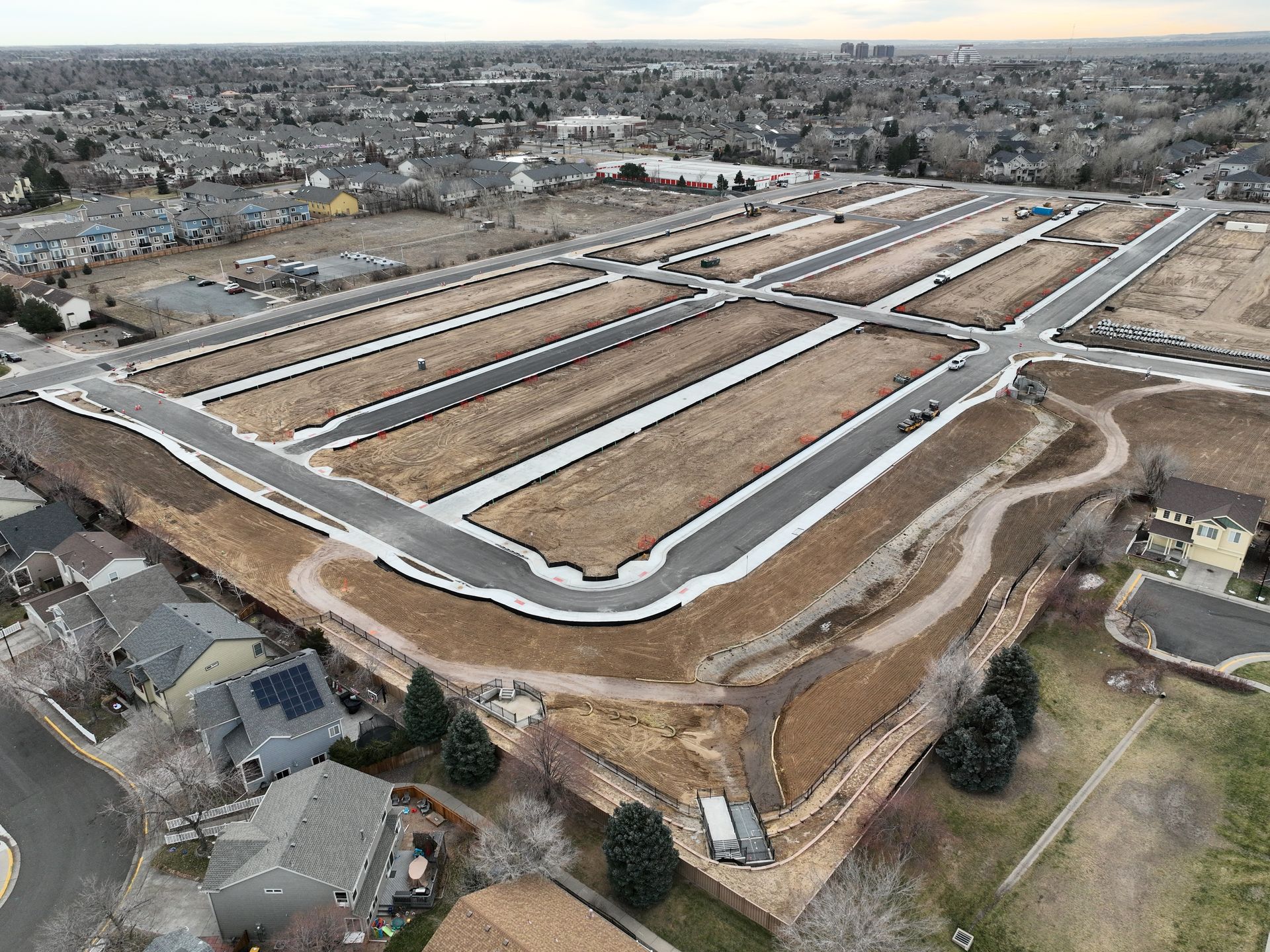An aerial view of a residential area with lots of houses and roads.