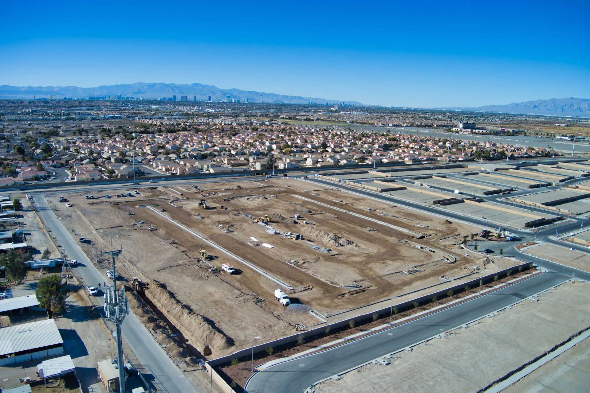 An aerial view of a residential area with mountains in the background.