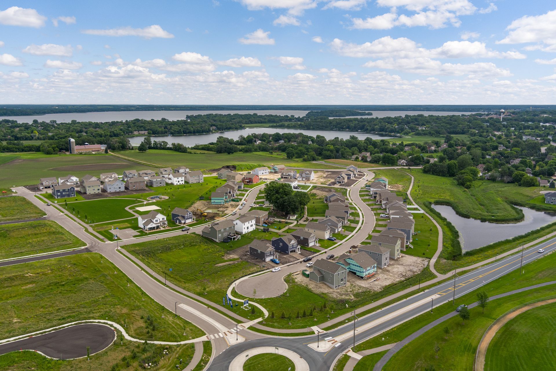 An aerial view of a residential area with a lake in the background.