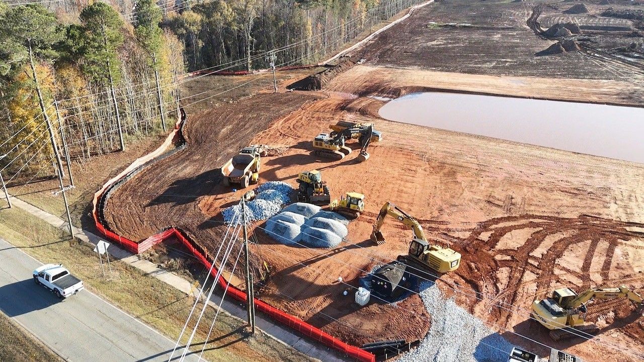 An aerial view of a construction site with tractors and bulldozers.