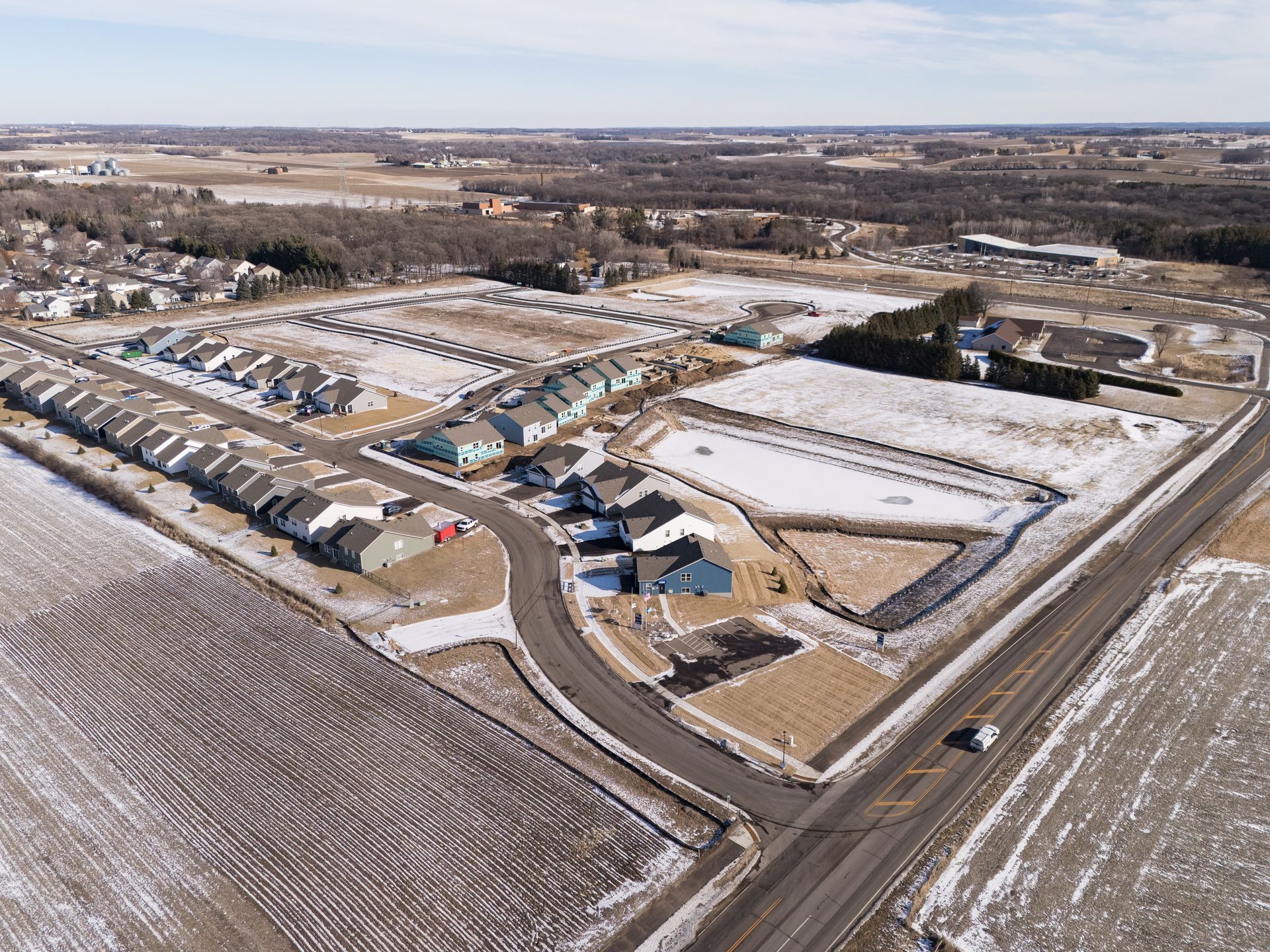 An aerial view of a residential area with snow on the ground.