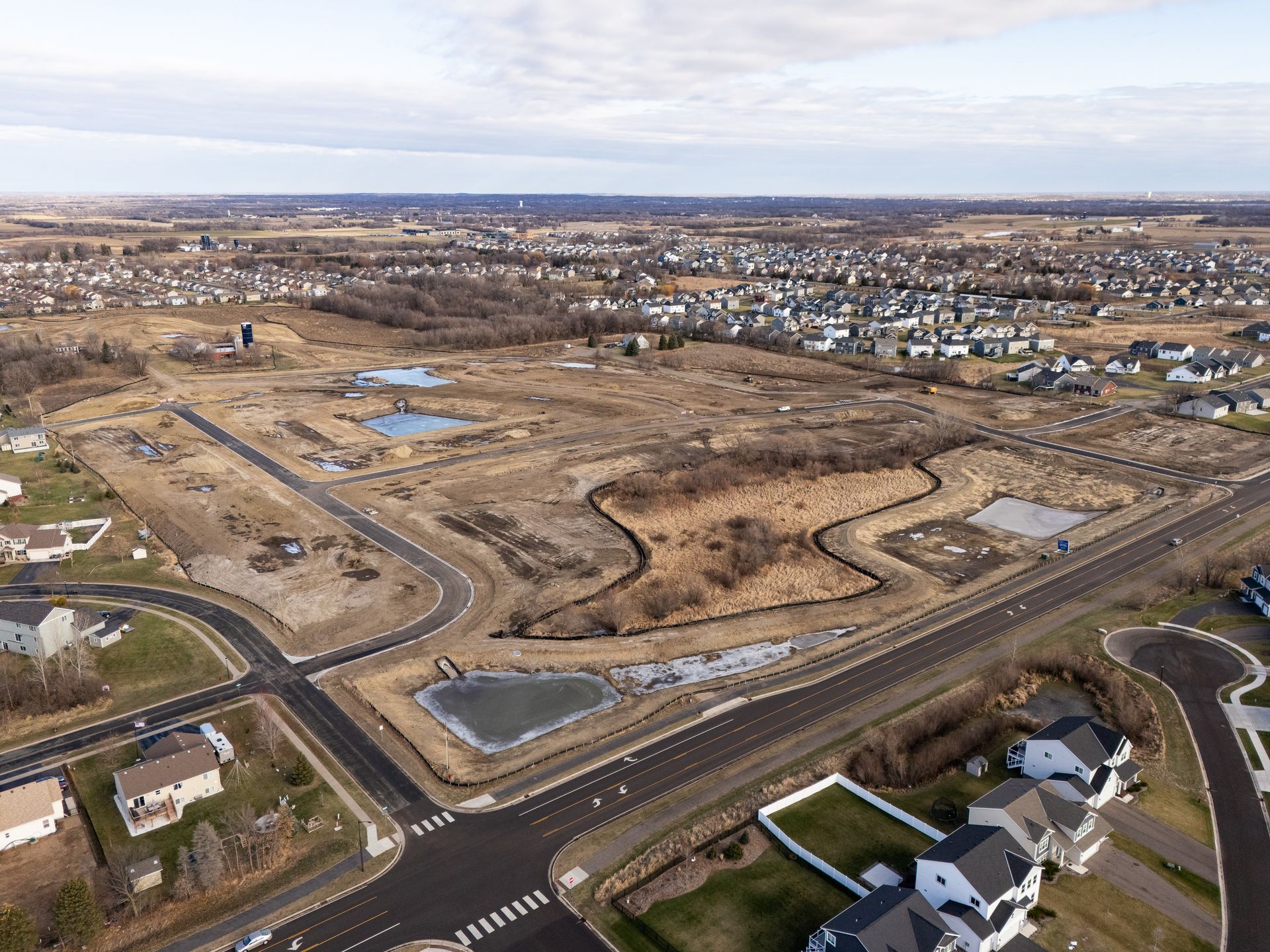An aerial view of a residential area with a lot of houses and roads.