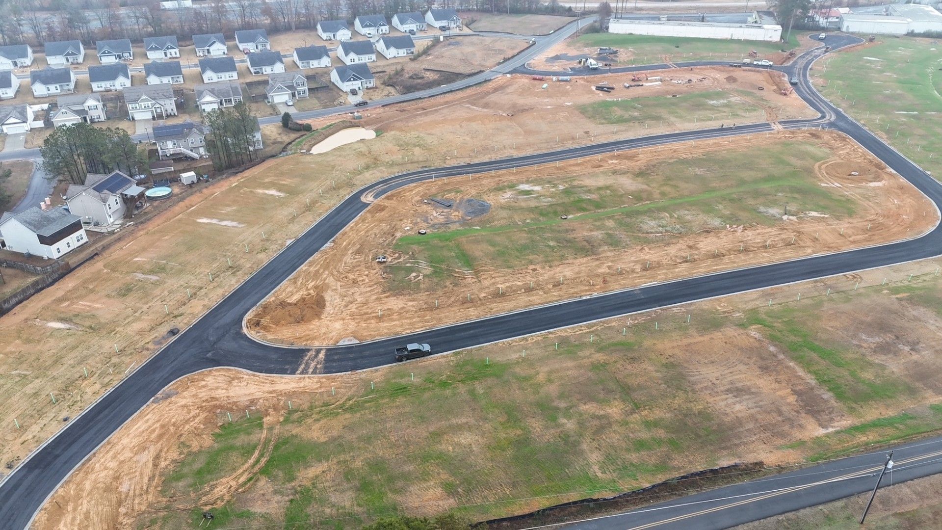 An aerial view of a residential area with a lot of houses and roads.