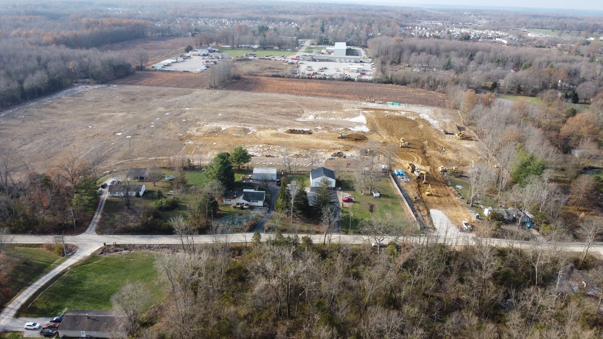 An aerial view of a construction site in the middle of a forest.