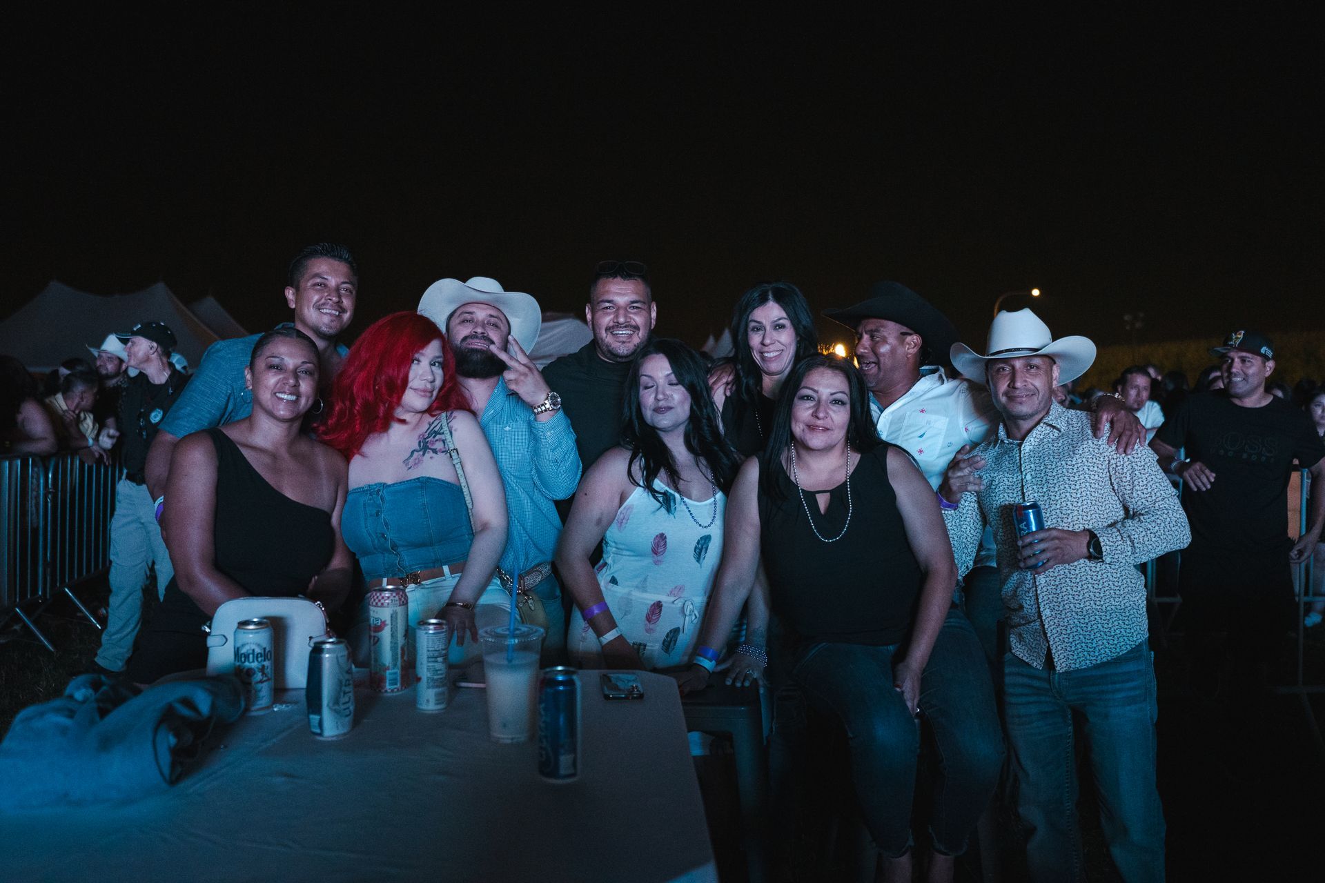 A group of people are posing for a picture at a concert.