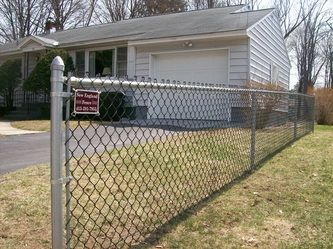 A Chain Link Fence in Front of a House – Pittsfield, MA - New England Fence