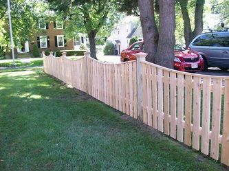 A Wooden Fence With a Red Car Parked Behind It – Pittsfield, MA - New England Fence