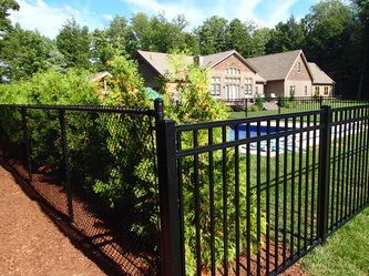 A Metal Fence Surrounds a Large House With a Pool – Pittsfield, MA - New England Fence