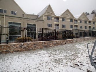 A Large Building With a Metal Fence – Pittsfield, MA - New England Fence