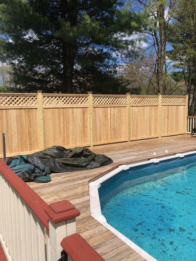 A Wooden Fence Surrounds a Swimming Pool – Pittsfield, MA - New England Fence