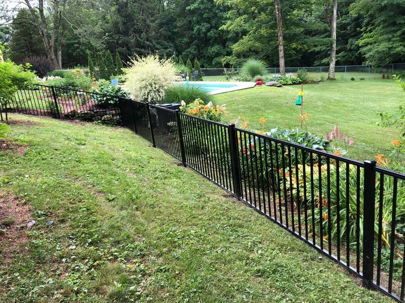 A Black Fence in a Yard With a Pool – Pittsfield, MA - New England Fence