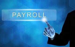 Business Hand Pushing Payroll Button - Payroll in Wheeling, WV
