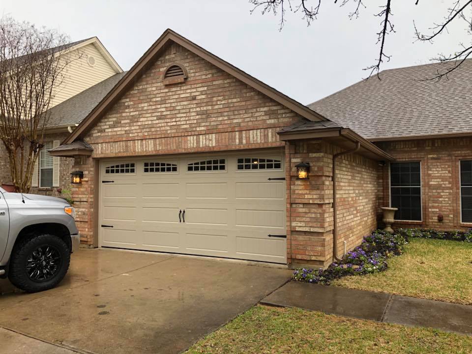 Garage Door Repair - A Garage Door In Front Of A House in Dallas/Fort Worth, TX