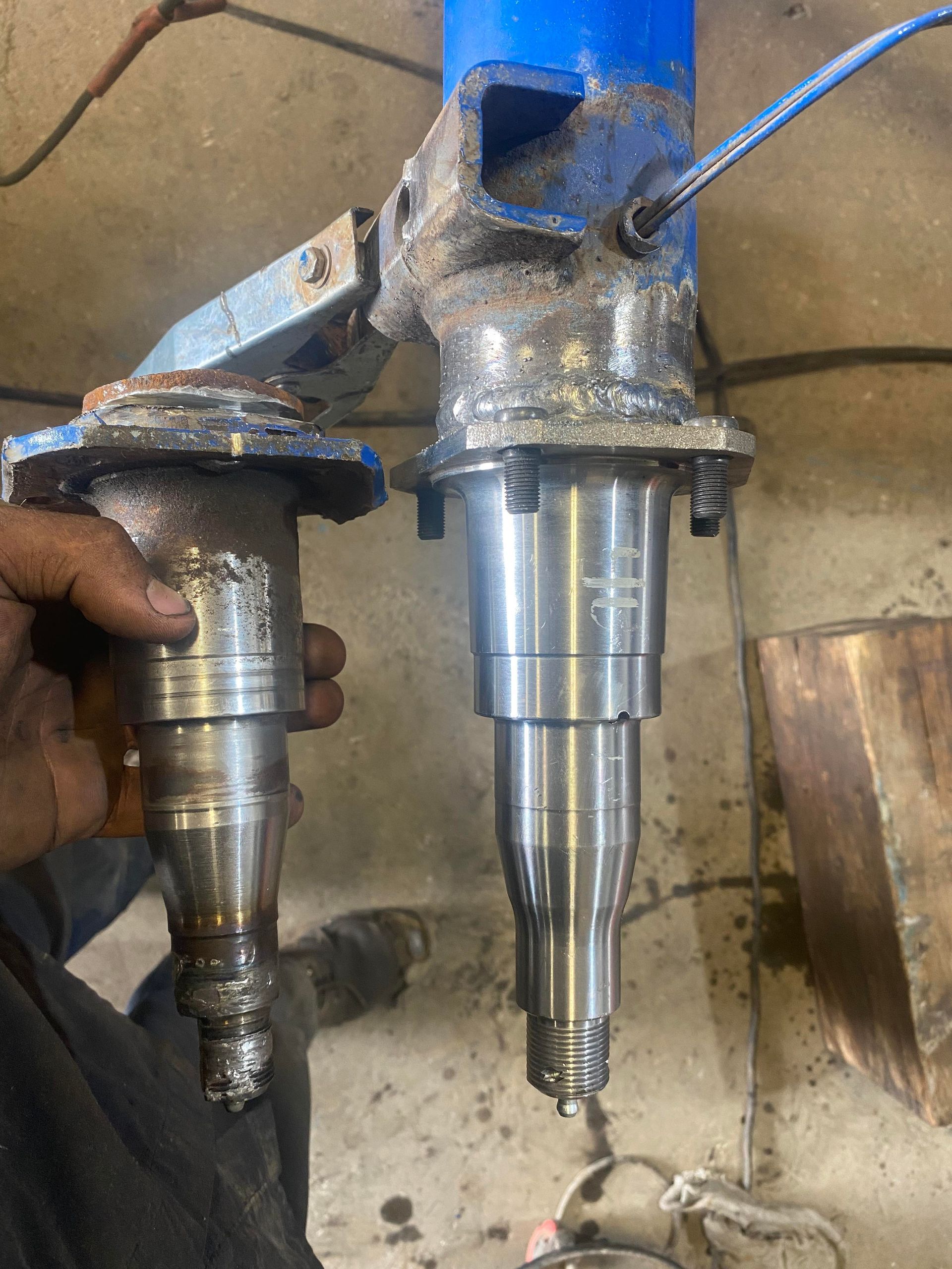 A person is holding two pieces of metal in their hands.