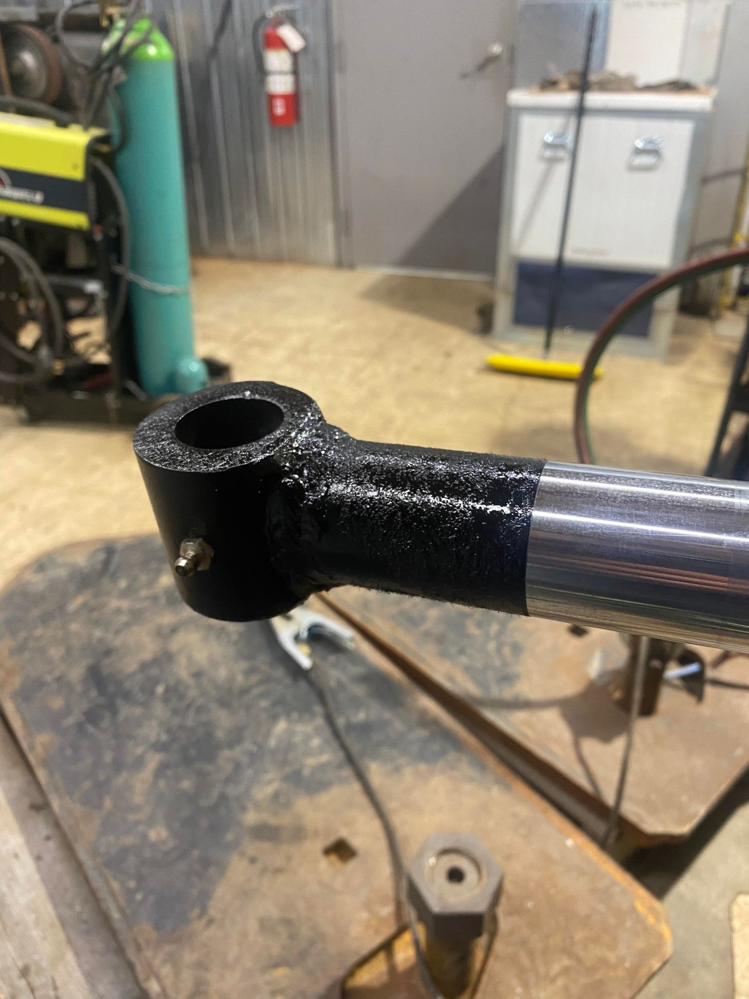 A piece of metal is sitting on top of a wooden table.