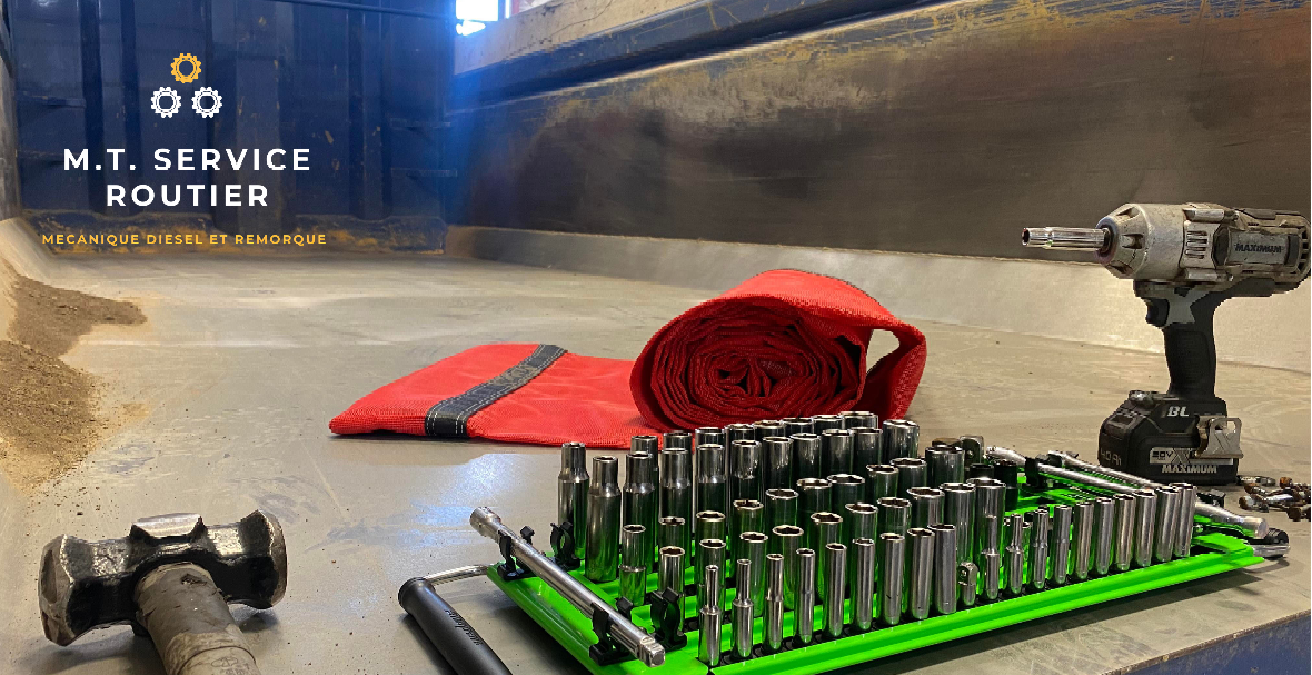 A drill , a hammer , a tie and a bunch of tools are on a table.