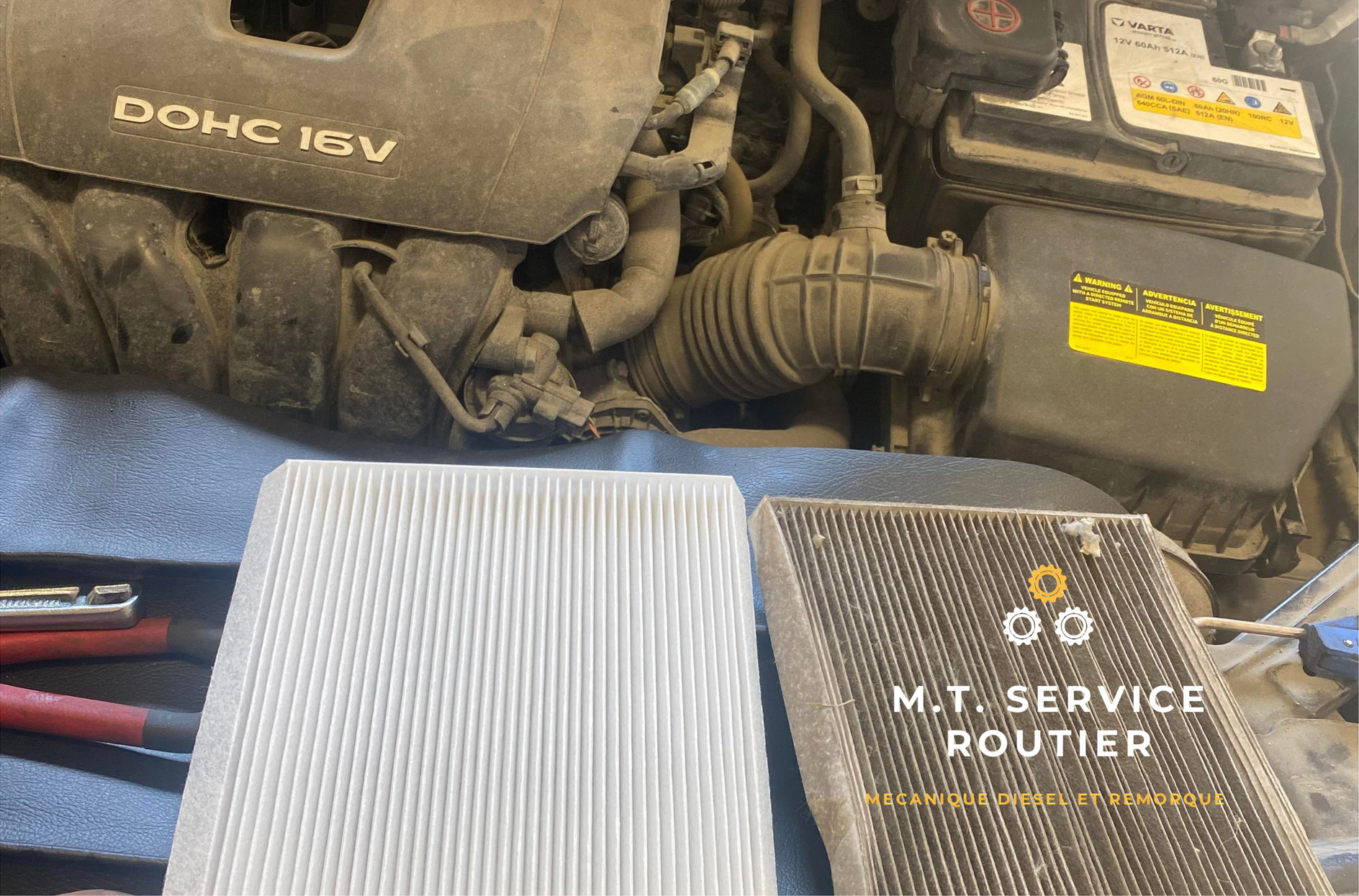 Two air filters are sitting under the hood of a car.