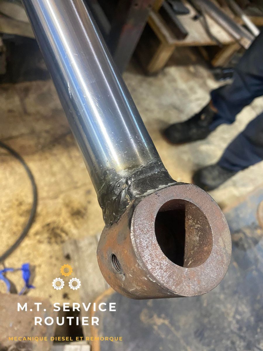 A close up of a metal pipe with a hole in it.