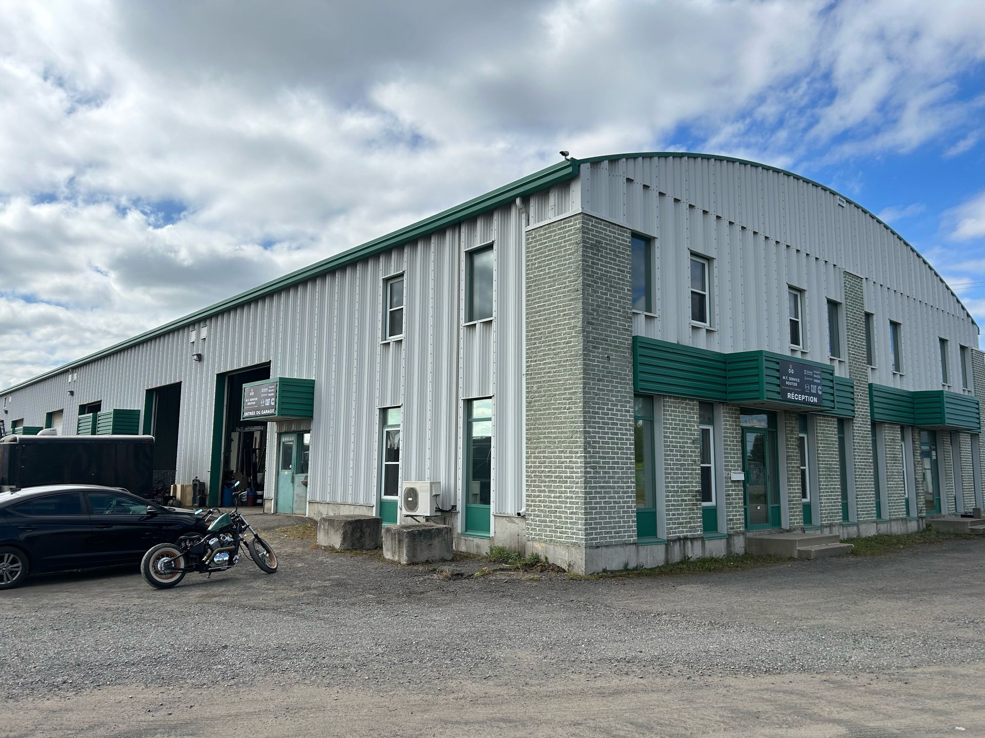 A large building with a motorcycle parked in front of it.