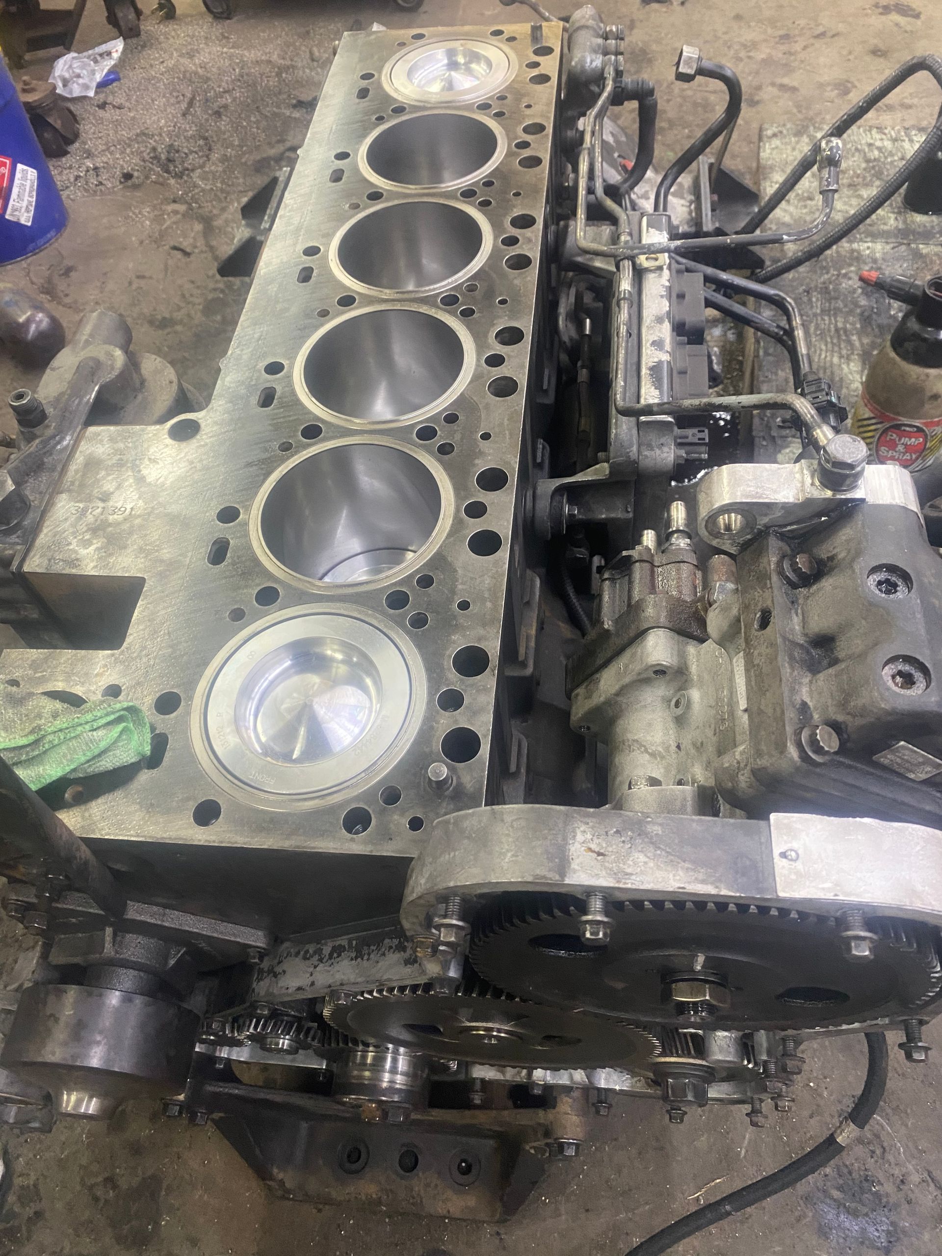 A large engine is being worked on in a garage.