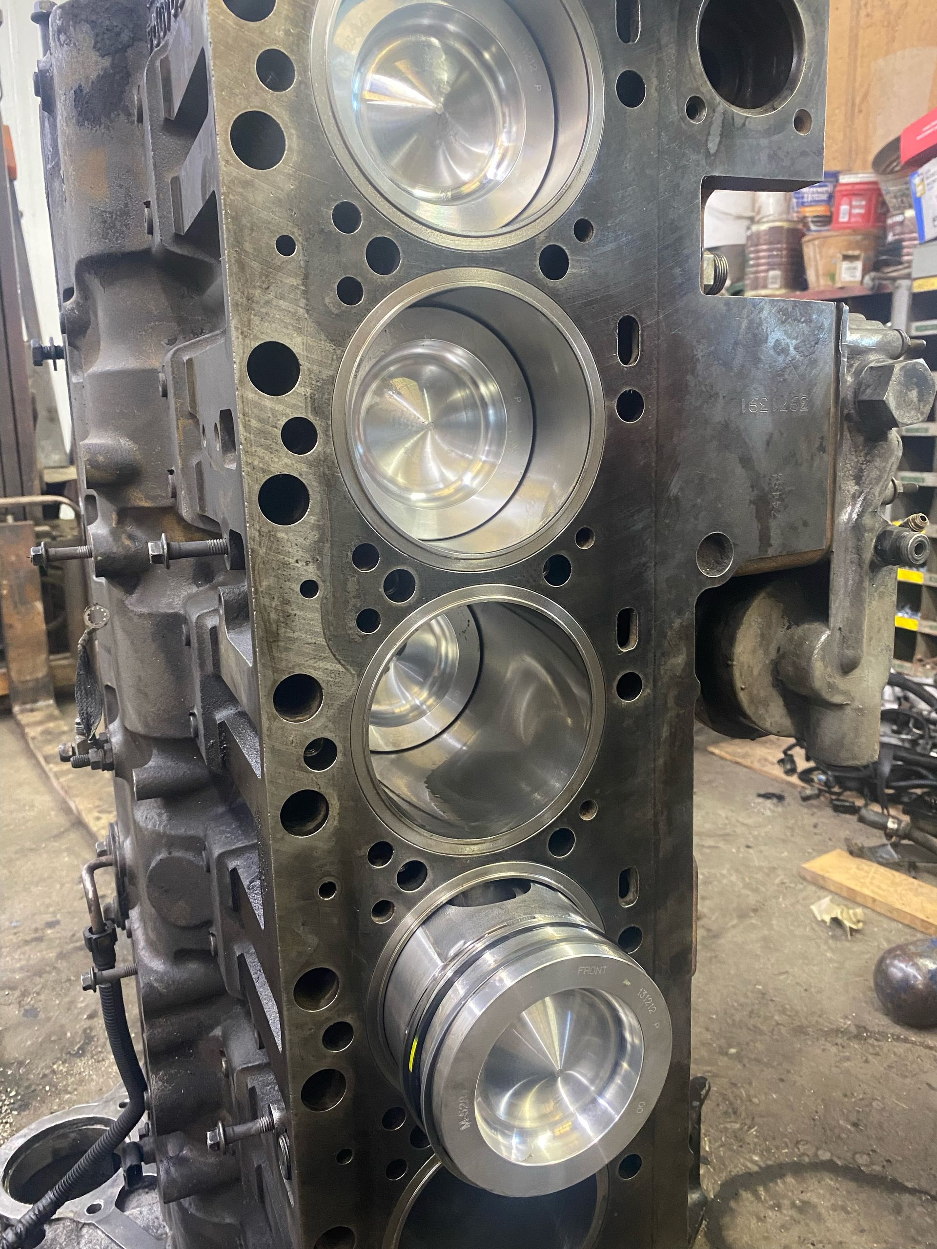 A close up of a cylinder block with pistons in it.