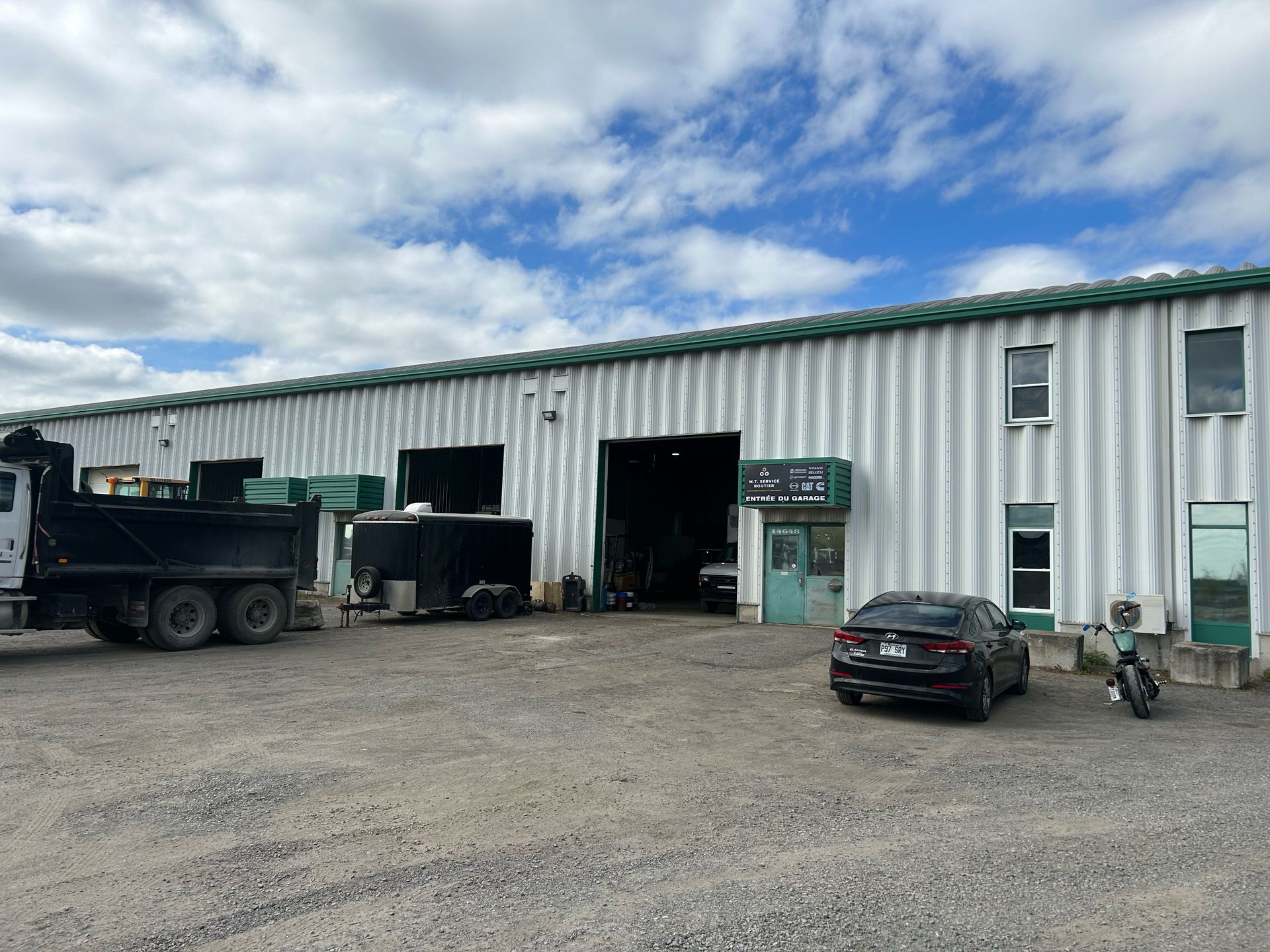 A dump truck is parked in front of a large building.