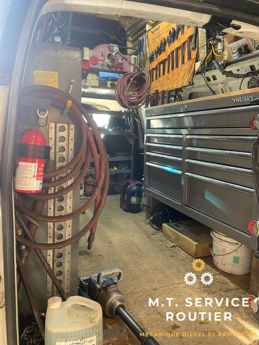 The inside of a van filled with tools and a fire extinguisher.