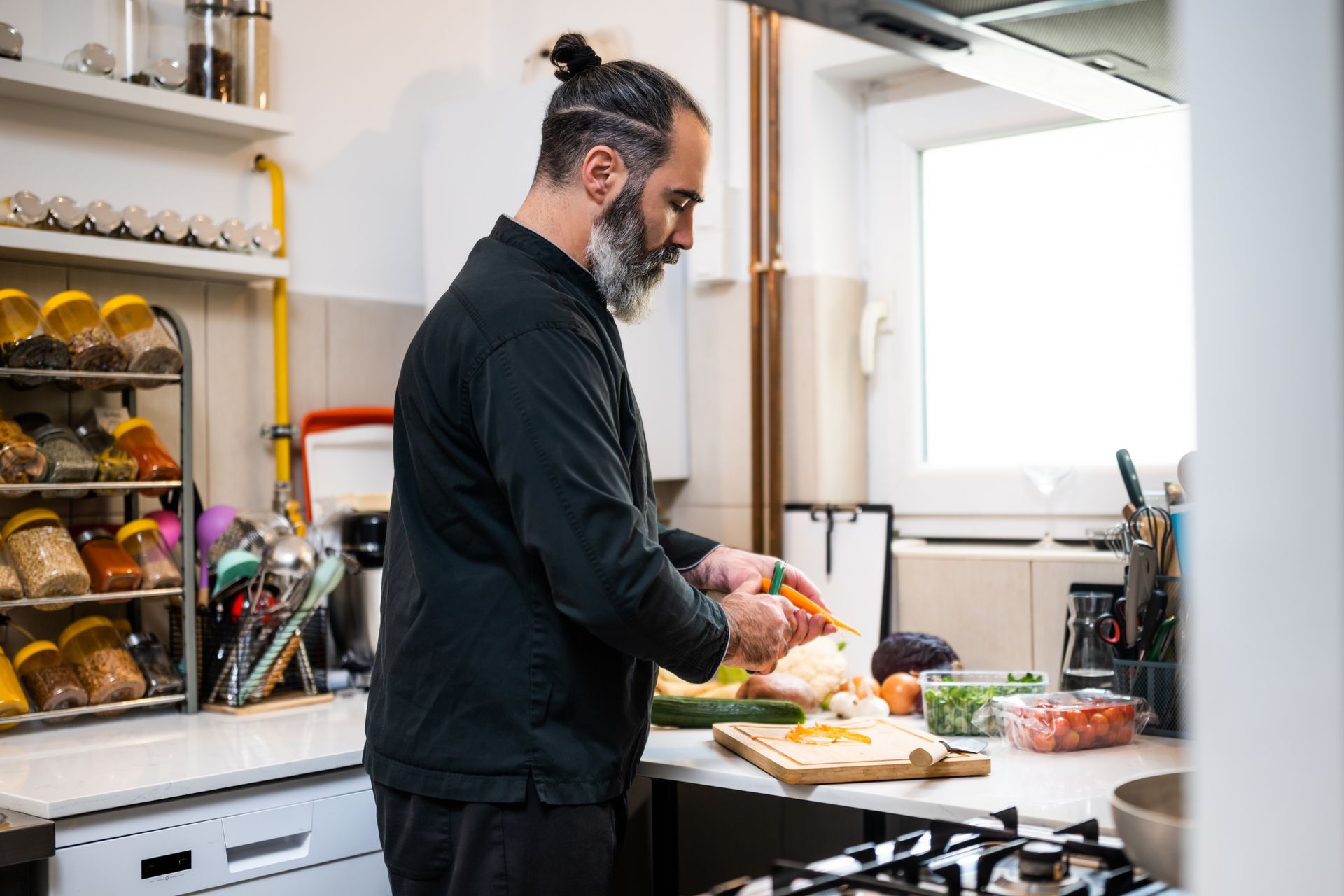 Professional chef is preparing meal in restaurant's kitchen.