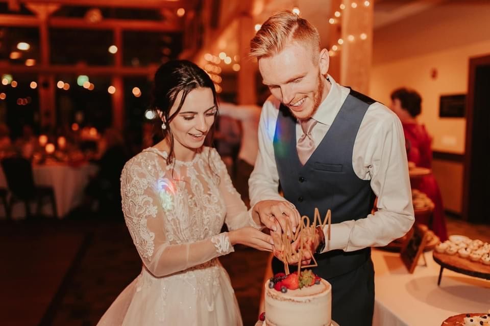Mix It Up! custom cake being cut into by the bride and groom