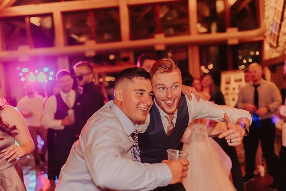 Mix It Up! providing dj services to an event where a two men are posing for a picture
