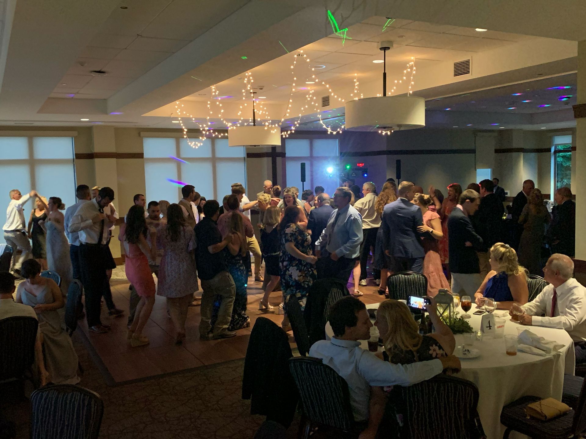 Mix It Up! providing dj services for a wedding, with a large group of people are dancing