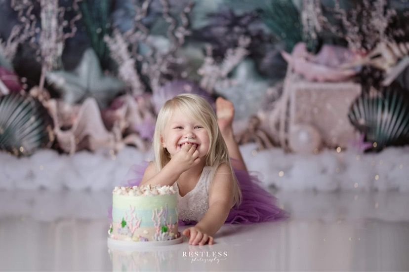 Mix It Up! Smash cakes: little girl eating her smash cake that is decorated for under the sea theme